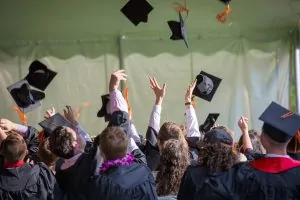 electrical engineer graduates throwing their cap as a celebration.